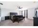 Spacious main bedroom featuring a tufted headboard bed, matching bench, and black accents at 2503 Calla Lily Cv, Kissimmee, FL 34758