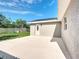 Backyard concrete patio, exterior door, and a well-kept lawn at 2629 Williston Dr, Lakeland, FL 33801