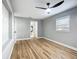 Bedroom showcasing wood-look floors, ceiling fan, and access to the en-suite bathroom at 2629 Williston Dr, Lakeland, FL 33801