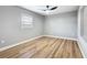 Cozy bedroom featuring wood-look floors, a ceiling fan, and a window for natural light at 2629 Williston Dr, Lakeland, FL 33801