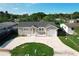 Aerial view of a one-story home with a private driveway and well manicured lawn at 2629 Williston Dr, Lakeland, FL 33801