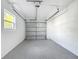 Clean garage with an automatic door, painted walls, and epoxy flooring at 2629 Williston Dr, Lakeland, FL 33801