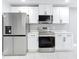 Modern kitchen with stainless steel appliances and stylish white cabinets at 2629 Williston Dr, Lakeland, FL 33801