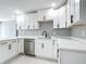 A bright kitchen with white cabinetry, stainless steel dishwasher and a modern faucet at 2629 Williston Dr, Lakeland, FL 33801