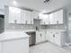 Bright kitchen showcasing white cabinetry, quartz countertops and stainless steel dishwasher at 2629 Williston Dr, Lakeland, FL 33801