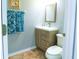 Bathroom featuring a light wooden vanity, mirror, towel rack with blue towels, and a toilet at 2722 Corybrooke Ln, Kissimmee, FL 34744