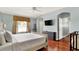 Light and airy bedroom with wood floors, queen bed, neutral decor, and a window for plenty of natural light at 2722 Corybrooke Ln, Kissimmee, FL 34744