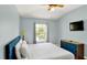 Bright bedroom with a large bed, a modern ceiling fan, and a window with natural light at 2722 Corybrooke Ln, Kissimmee, FL 34744