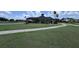 View of the exterior of the clubhouse on a sunny day with lush green lawn at 2722 Corybrooke Ln, Kissimmee, FL 34744