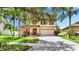 Charming home featuring mature trees, a two-car garage, and a well-maintained lawn at 2722 Corybrooke Ln, Kissimmee, FL 34744