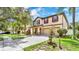 Inviting home with a manicured lawn, mature trees, and a spacious two-car garage at 2722 Corybrooke Ln, Kissimmee, FL 34744