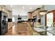 Open concept kitchen with wooden cabinets, stainless steel appliances, island, and a view of the living room at 2722 Corybrooke Ln, Kissimmee, FL 34744