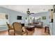 Cozy living room with tile flooring, ceiling fan, sofa, and two chairs with natural light through the windows at 2722 Corybrooke Ln, Kissimmee, FL 34744