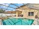 Backyard swimming pool with spa, covered patio, and landscaped surroundings at 2722 Corybrooke Ln, Kissimmee, FL 34744