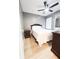 Intimate bedroom with wood-look flooring, ceiling fan, and modern furniture at 2735 N Poinciana Blvd # 95, Kissimmee, FL 34746