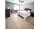 Cozy bedroom with wood-look flooring, ceiling fan, and ample natural light at 2735 N Poinciana Blvd # 95, Kissimmee, FL 34746