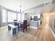 Open dining area with modern chandelier, wood flooring, and adjacent kitchen at 2735 N Poinciana Blvd # 95, Kissimmee, FL 34746