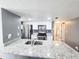 Updated kitchen with stainless steel appliances, granite countertops, and tile backsplash at 2735 N Poinciana Blvd # 95, Kissimmee, FL 34746