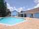 Community pool with a bright blue structure, clear blue water, and a spacious brick patio area at 2735 N Poinciana Blvd # 95, Kissimmee, FL 34746