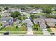 Aerial view of a beautiful home with lush landscaping, solar panels and serene pond at 3038 Elbib, St Cloud, FL 34769