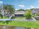 Backyard view of a charming home with a pond, white fence, and lush greenery at 3038 Elbib, St Cloud, FL 34769