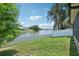 Charming backyard with a white picket fence and scenic pond view, perfect for relaxation at 3038 Elbib, St Cloud, FL 34769