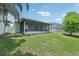 Spacious backyard with a screened lanai providing an ideal space for outdoor living and entertaining at 3038 Elbib, St Cloud, FL 34769