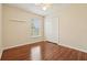 Bedroom with hardwood floors, ceiling fan, closet, and window providing plenty of light at 3038 Elbib, St Cloud, FL 34769