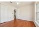 Cozy bedroom with wood floors, white trim, and a window offering natural light, creating a warm ambiance at 3038 Elbib, St Cloud, FL 34769