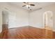 Spacious bedroom with hardwood floors, archway to bathroom, and a view of the en-suite bathroom at 3038 Elbib, St Cloud, FL 34769