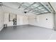Spacious two-car garage with painted walls, high ceiling, and plenty of room for storage and parking at 3038 Elbib, St Cloud, FL 34769