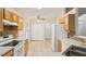 Eat-in kitchen features tile floors, backsplash, and a view to dining area at 3038 Elbib, St Cloud, FL 34769