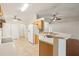 Open kitchen with white appliances, tile floors, and breakfast bar overlooking the living area at 3038 Elbib, St Cloud, FL 34769