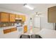 Bright kitchen with tiled floors, classic white appliances, and ample cabinet space at 3038 Elbib, St Cloud, FL 34769