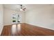 An empty living room featuring sleek wood floors and French doors leading to the outside at 3038 Elbib, St Cloud, FL 34769
