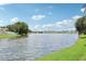 Scenic view of the serene pond surrounded by lush greenery and charming homes at 3038 Elbib, St Cloud, FL 34769