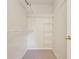 Spacious walk-in closet with white shelving and a carpeted floor, offering ample storage space at 3038 Elbib, St Cloud, FL 34769