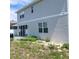 View of the house with a patio and some green space in the backyard at 312 Lake Smart Cir, Winter Haven, FL 33881