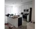 Bright kitchen with stainless steel appliances, a center island, and ample counter space at 312 Lake Smart Cir, Winter Haven, FL 33881