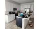 Spacious kitchen featuring white cabinets, a center island, and stainless steel appliances at 312 Lake Smart Cir, Winter Haven, FL 33881