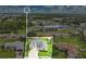 Aerial view of a home with great curb appeal, a spacious driveway, and well-maintained landscaping at 3261 Sawgrass Creek Cir, St Cloud, FL 34772