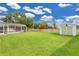 Large backyard with a screened-in lanai and storage shed offers ample outdoor space at 3261 Sawgrass Creek Cir, St Cloud, FL 34772