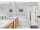 Bathroom featuring double sinks, a tub, and a separate glass-enclosed shower at 3261 Sawgrass Creek Cir, St Cloud, FL 34772