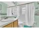Standard bathroom with shower and tub combination, white tile, and single sink at 3261 Sawgrass Creek Cir, St Cloud, FL 34772