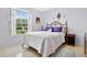 Cozy bedroom with a large window, neutral walls, and carpet flooring at 3261 Sawgrass Creek Cir, St Cloud, FL 34772