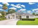 Charming single-story home with an American flag, well-maintained lawn and a palm tree in the front yard at 3261 Sawgrass Creek Cir, St Cloud, FL 34772