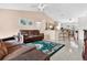 Spacious living area features an open layout to the kitchen, with large windows and vaulted ceilings at 3261 Sawgrass Creek Cir, St Cloud, FL 34772