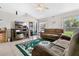Inviting living room features a vaulted ceiling, a comfortable sofa, and a sliding door leading to the backyard at 3261 Sawgrass Creek Cir, St Cloud, FL 34772