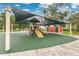 Community playground featuring a shaded play structure with slides and climbing elements at 3261 Sawgrass Creek Cir, St Cloud, FL 34772