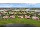 Aerial view of a residential community with well-maintained lawns and scenic lake views at 3617 Northwoods Dr, Kissimmee, FL 34746